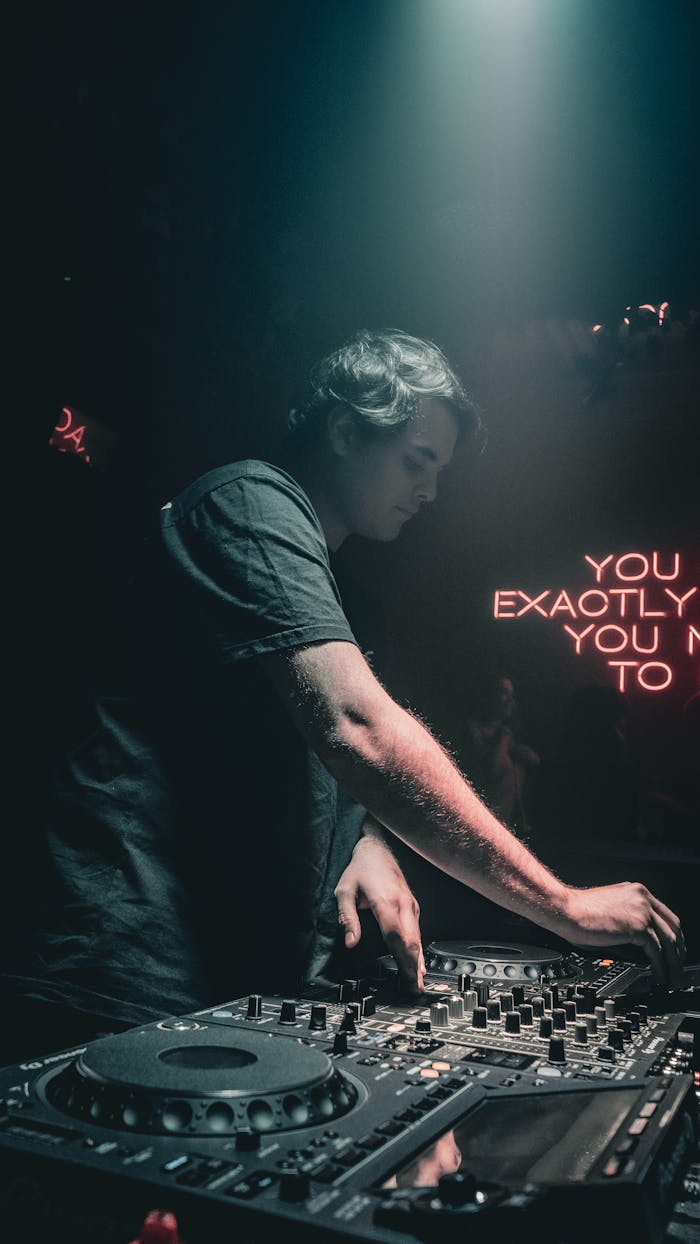 DJ spinning at a vibrant nightclub with neon lights and electronic music vibe.